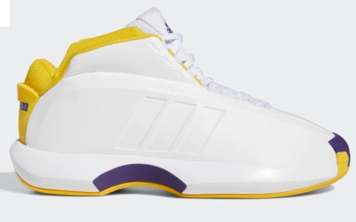 Side view of white, yellow, and purple adidas shoe.